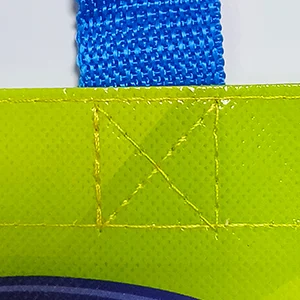 Close-up of the handle attachment on a bag with "X" stitch reinforcement