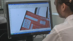 Designer creating a custom shopping bag design on a computer