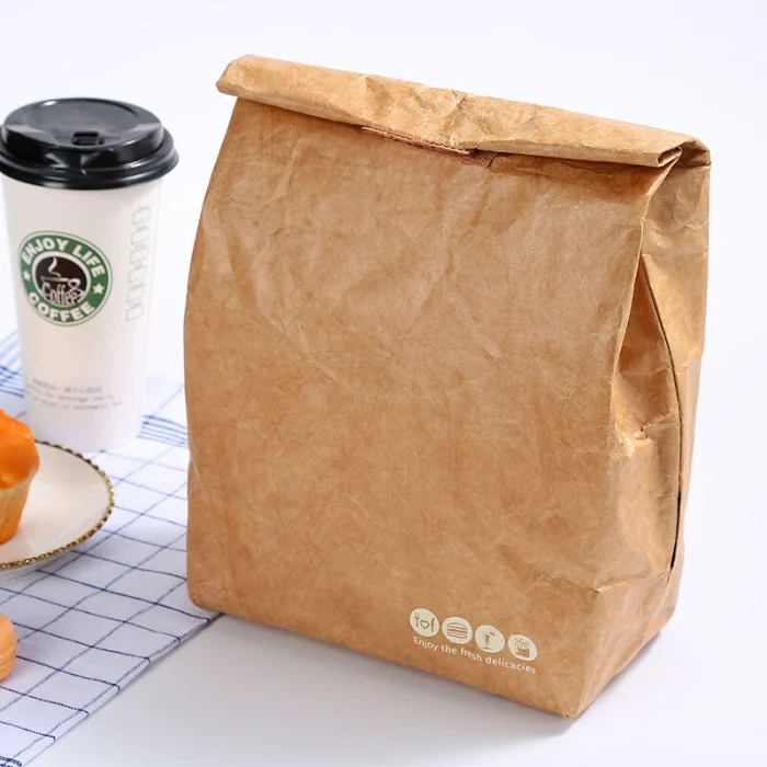 A brown DuPont paper (Tyvek) cooler bag with a bottom, no handles, a roll-top closure with velcro, and a custom logo printed on it, showcasing customizable options for size, material, and logo