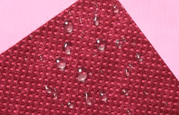 Nonwoven fabric showcasing its water resistance, ideal for various uses