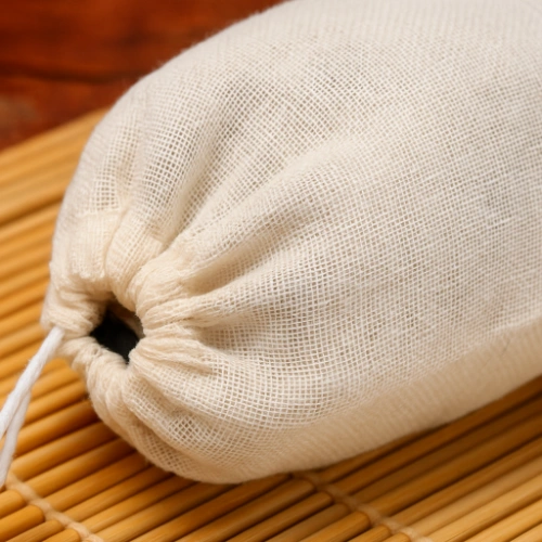 Close-up of a natural muslin bag tied with a drawstring, highlighting the blog topic How to Clean and Maintain Muslin Bags.