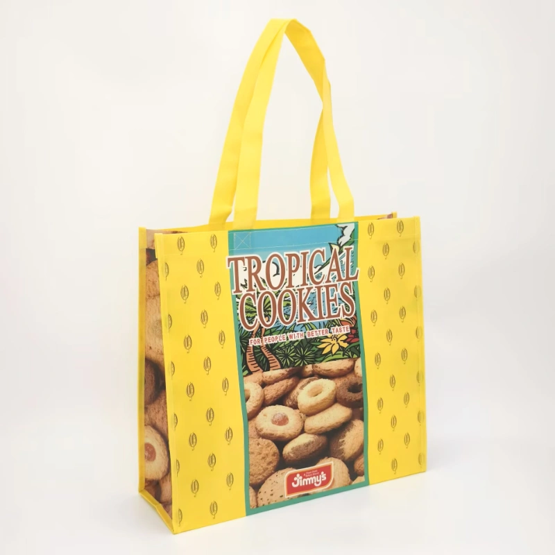 Yellow non-woven tote bag with colorful cookie-themed print and side gussets, shown in an angled front view, customizable in size, material, style, and printing.