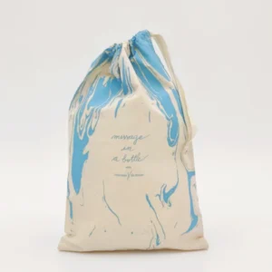 Front view of a thin cotton gift bag with large blue marble UV print and drawstring closure, customizable in size, material, style, and printing.