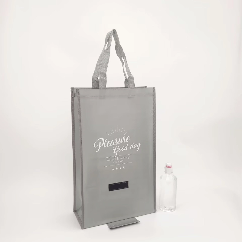 Front view of a gray upright non-woven tote bag with long handles and white lettering, shown with a water bottle for scale, customizable in size, material, style, and printing.