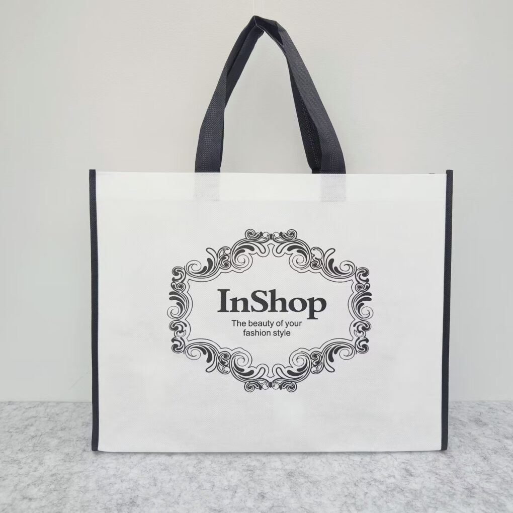 White-colored non woven bag positioned next to a canvas bag, illustrating the comparison between non woven bags vs canvas bags.