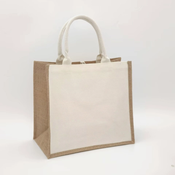 Front view of a structured jute tote bag with full white canvas panel and white cotton rope handles, ideal for branding, customizable in size, material, style, and printing.