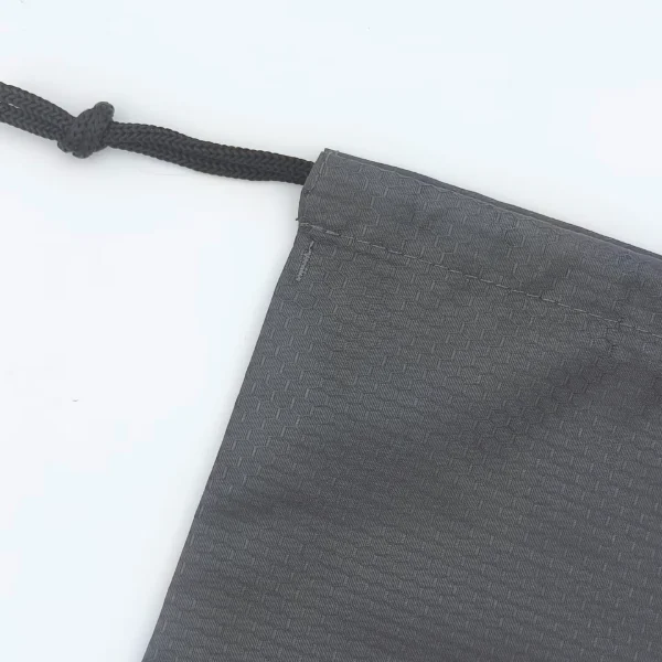 black drawstring bag close up top detail