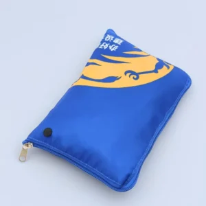 Top view of a folded royal blue drawstring backpack in rectangular shape with zipper and snap closure, customizable in size, material, style, and printing