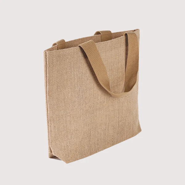 Angled side view of a burlap tote bag with wide bottom and brown flat woven handles, customizable in size, material, style, and printing.