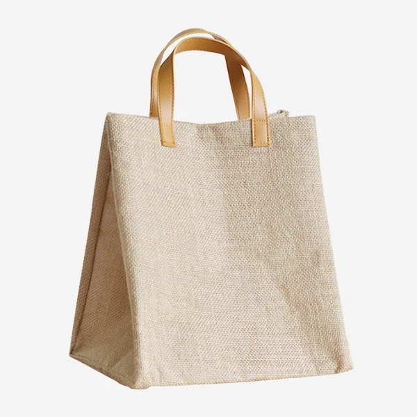 Natural jute tote bag with light brown PU leather handles, photographed from a front angle, simple and elegant style, customizable in size, material, style, and printing.