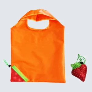 Orange reusable shopping bag with folded strawberry-shaped pouch beside it, practical design, customizable in size, material, style, and printing.