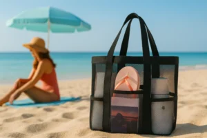 Black mesh swim bag with flip-flops and bottles on beach – How to Choose the Right Mesh Swim Bags