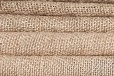 Stacked layers of coarse burlap fabric for jute bag making
