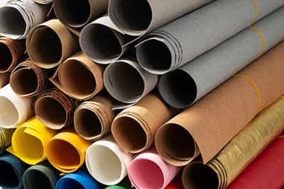 washable kraft paper in a variety of colors and thicknesses shown as rolled sheets for bag making