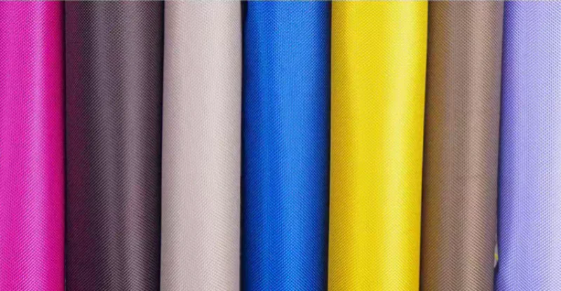 Everything You Need to Know about PVC Fabric featuring colorful Oxford fabric coated with PVC, showing smooth waterproof surfaces and textile texture.