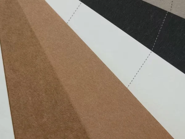 A close-up view of unwashed washable kraft paper sheets showing a natural brown surface with layered material samples.