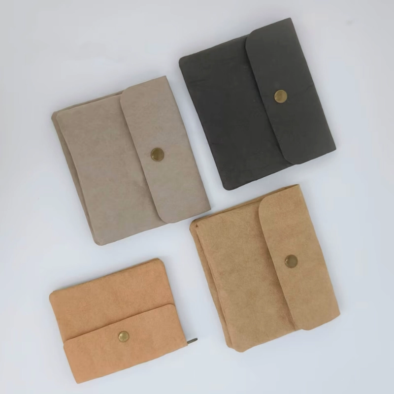 Several washable kraft coin purses with snap closures arranged on a light background.