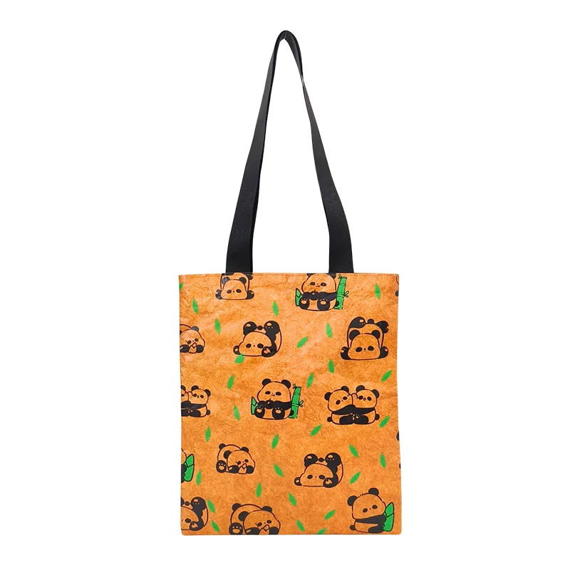 A soft Tyvek bag with long black shoulder straps, featuring an all-over illustrated pattern on a flat rectangular tote shape against a white background.