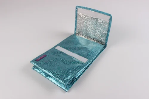 Close-up of a bag showing flap closure design with a fold-over panel and hook-and-loop fastening area.