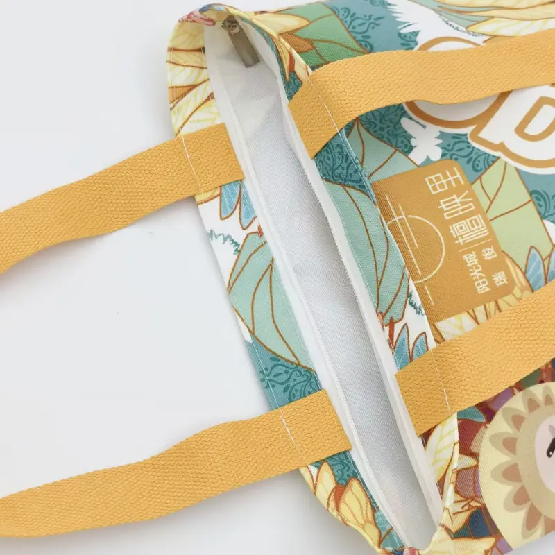 Canvas tote bag showing a zipper closure sewn directly along the top opening of the bag.