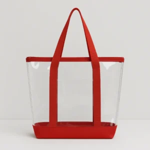 A clear tote bag with red handles and base, illustrating Top-Selling Clear Bag Styles for B2B in 2026.