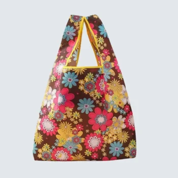 Front view of a foldable shopping bag with colorful floral patterns on a dark brown background, customizable in size, material, style, and printing.