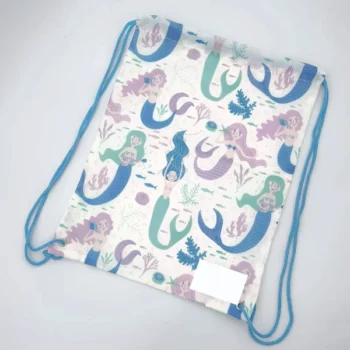 Top-down view of a mermaid-pattern drawstring backpack with blue drawcords, featuring a full-cover playful design, customizable in size, material, style, and printing.